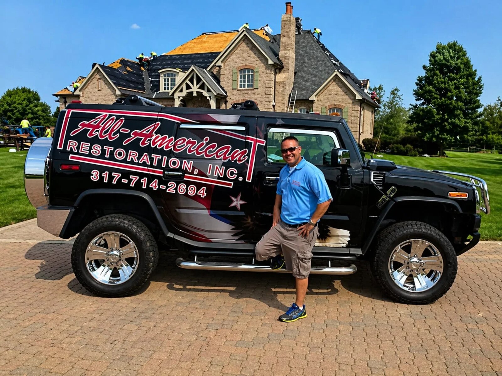 Brad VanBibber of All-American Restoration, Inc. in front of a large roof replacement in progress